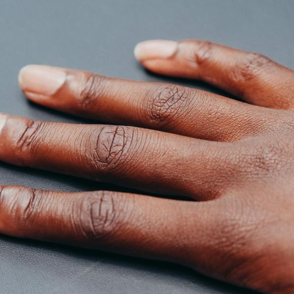 A detail shot of hands in a meditative mudra.