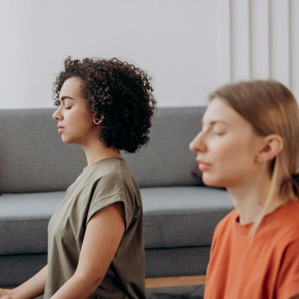 Person sitting calmly with eyes closed, focusing on breath.